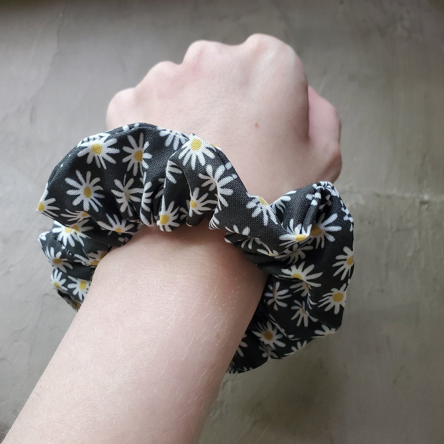 Scrunchie shown on my wrist for size reference. Fabric sticks out about an inch from the center of the scrunchie.