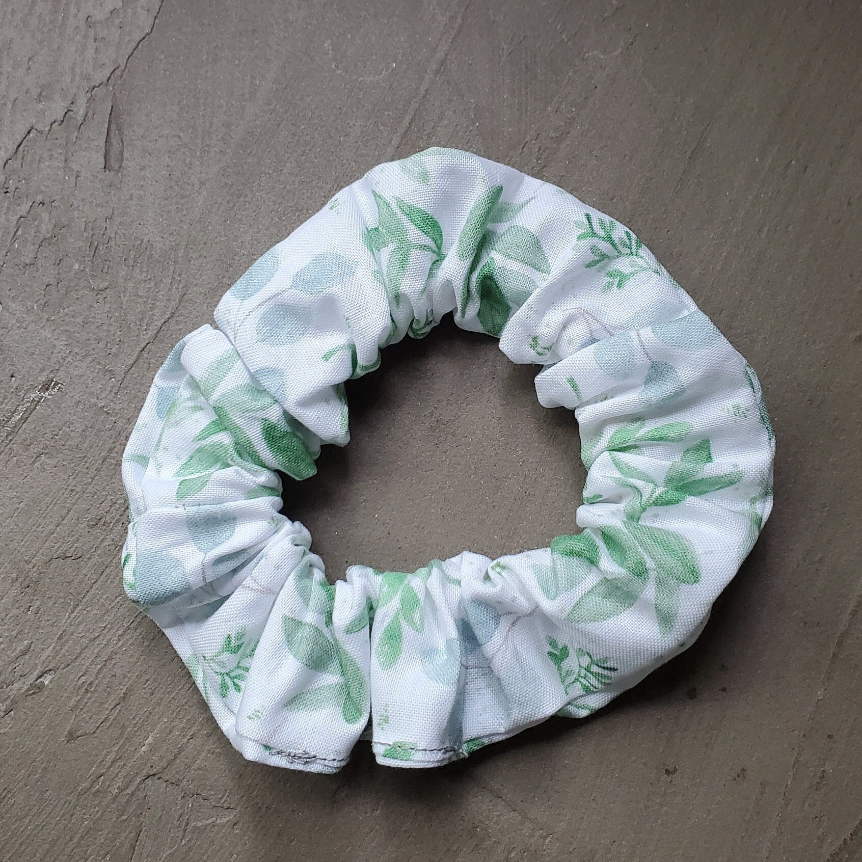 Scrunchie in natural sunlight on a concrete background.