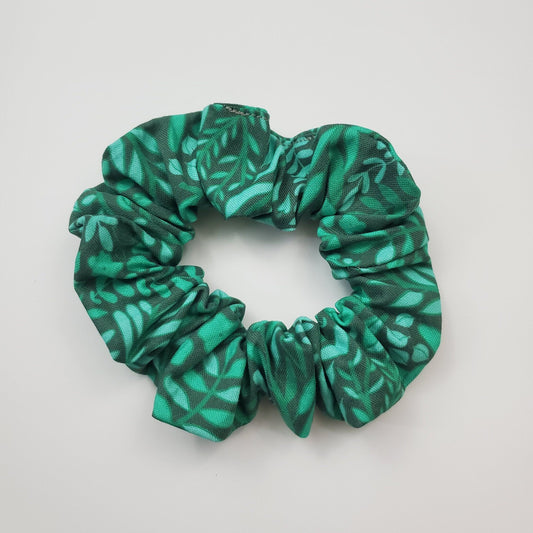 Dark green scrunchie with lighter green printed leaves and vines.