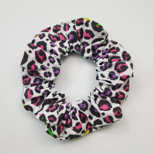Scrunchie with rainbow cheetah print on a white background.