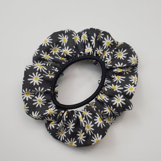 Black with white daisies Scrunchie with a regular black hair tie on top to show the size.