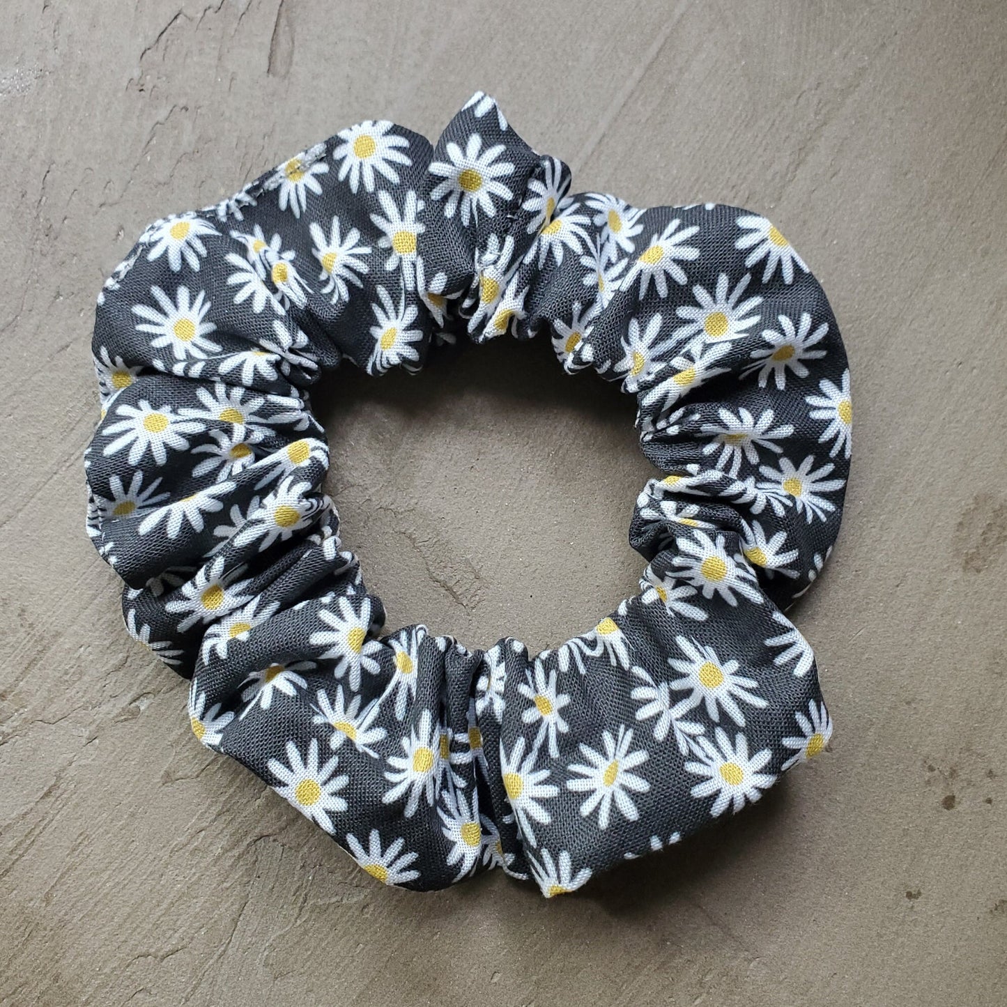 Scrunchie in natural sunlight on a concrete background.