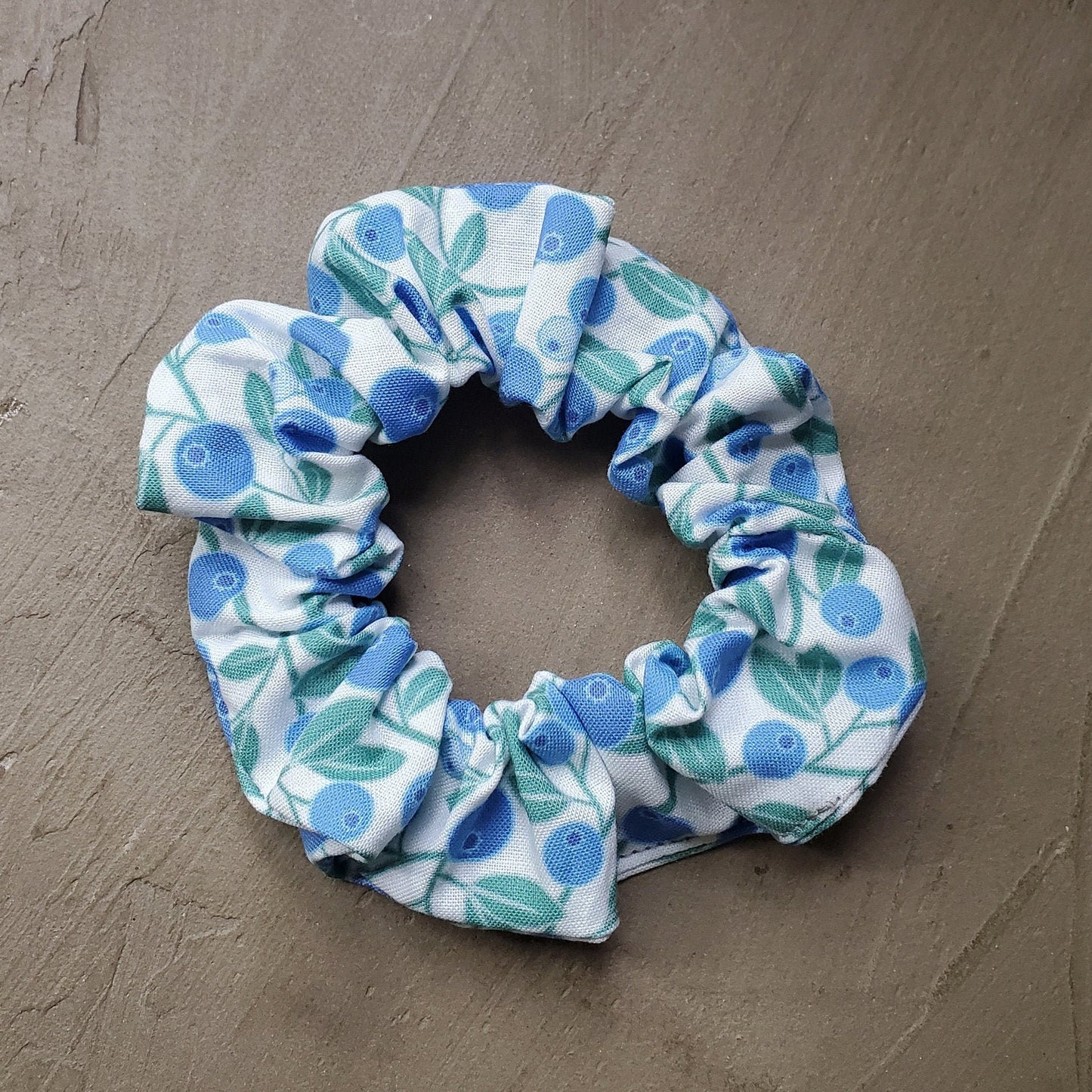 Scrunchie in natural sunlight on a concrete background.