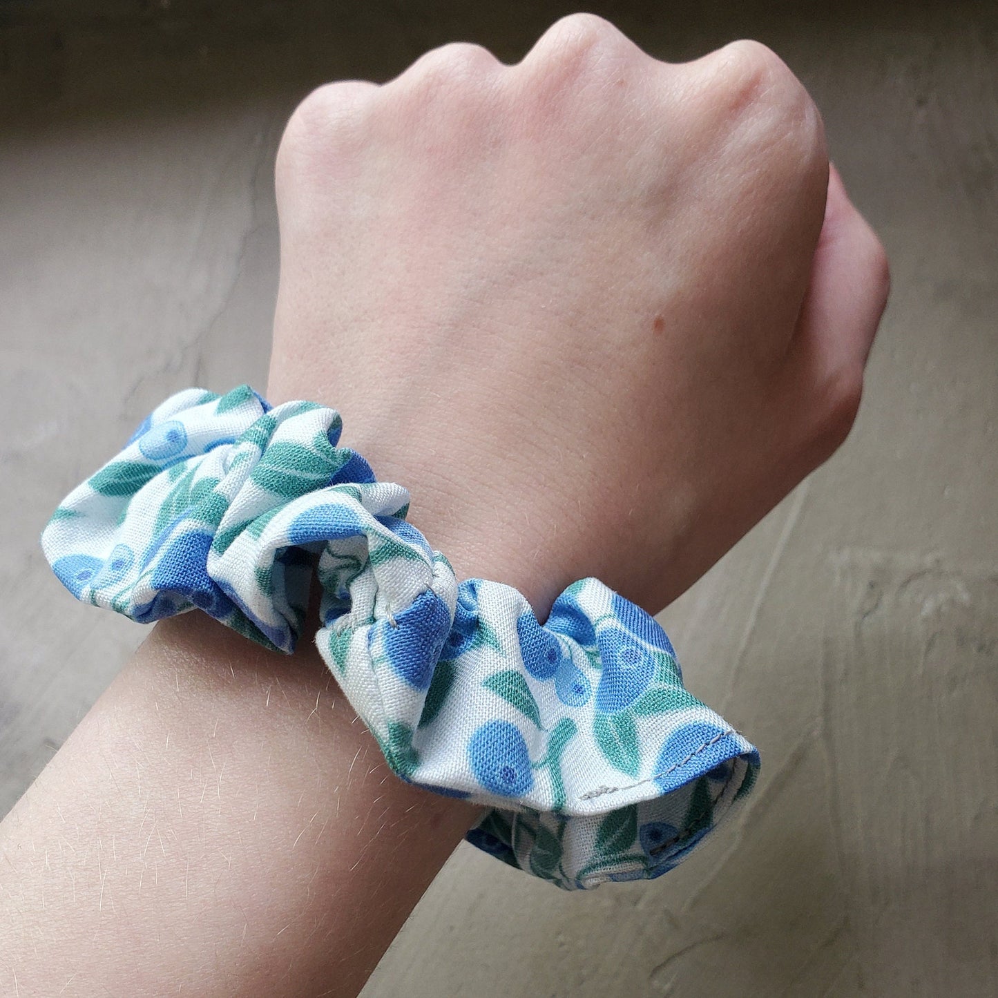 Scrunchie shown on my wrist for size reference. Fabric sticks out about an inch from the center of the scrunchie.