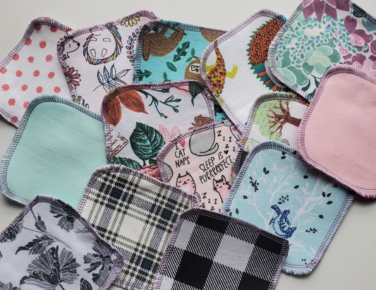 Random Print Cotton Rounds, photo of a scattered assortment of reusable cotton rounds in various prints and colors.