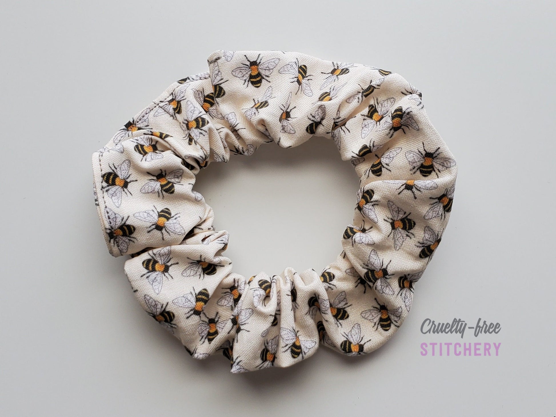 Bee print scrunchie on a plain white background.