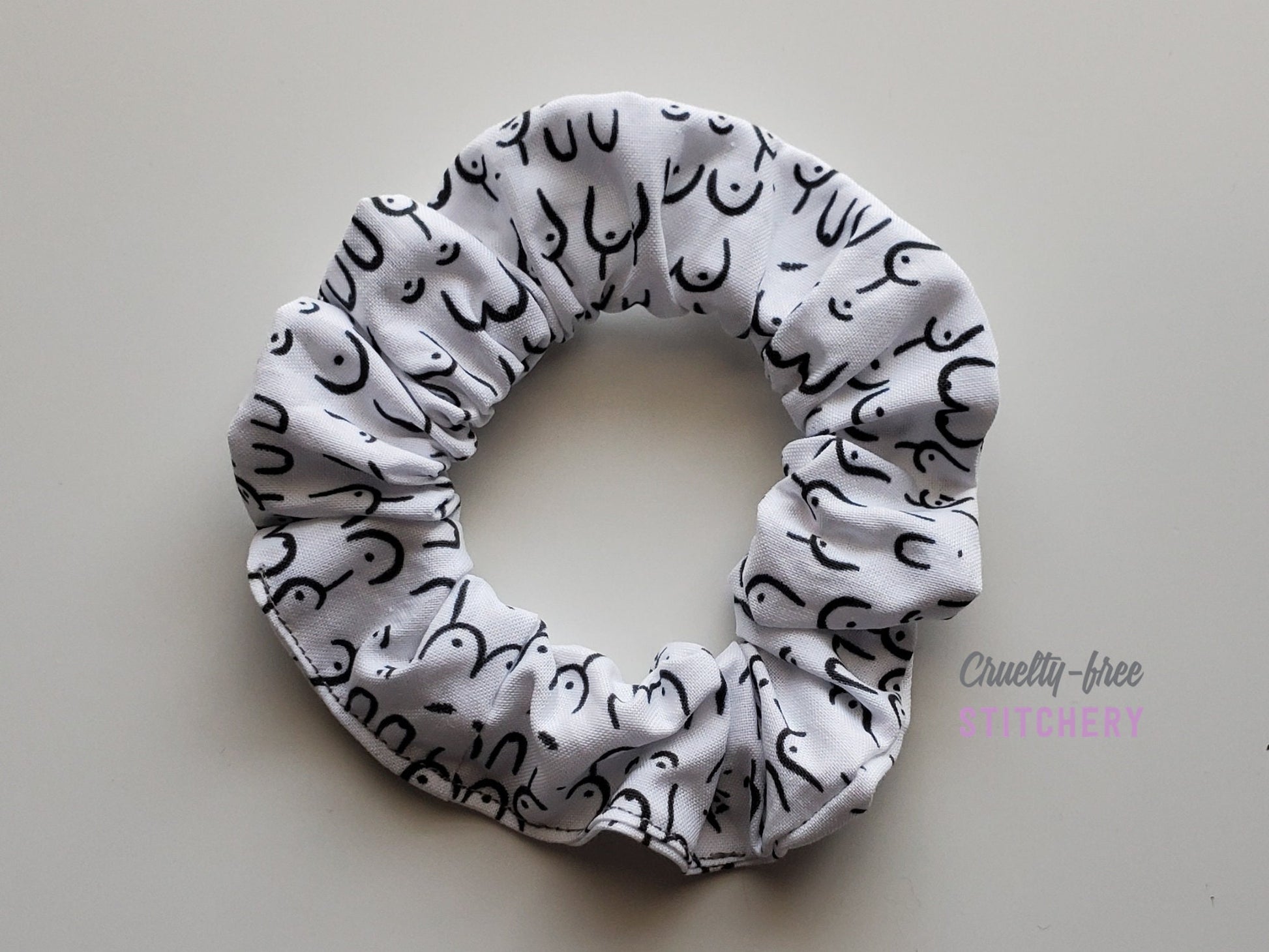 Boobs print black and white scrunchie in natural lighting.