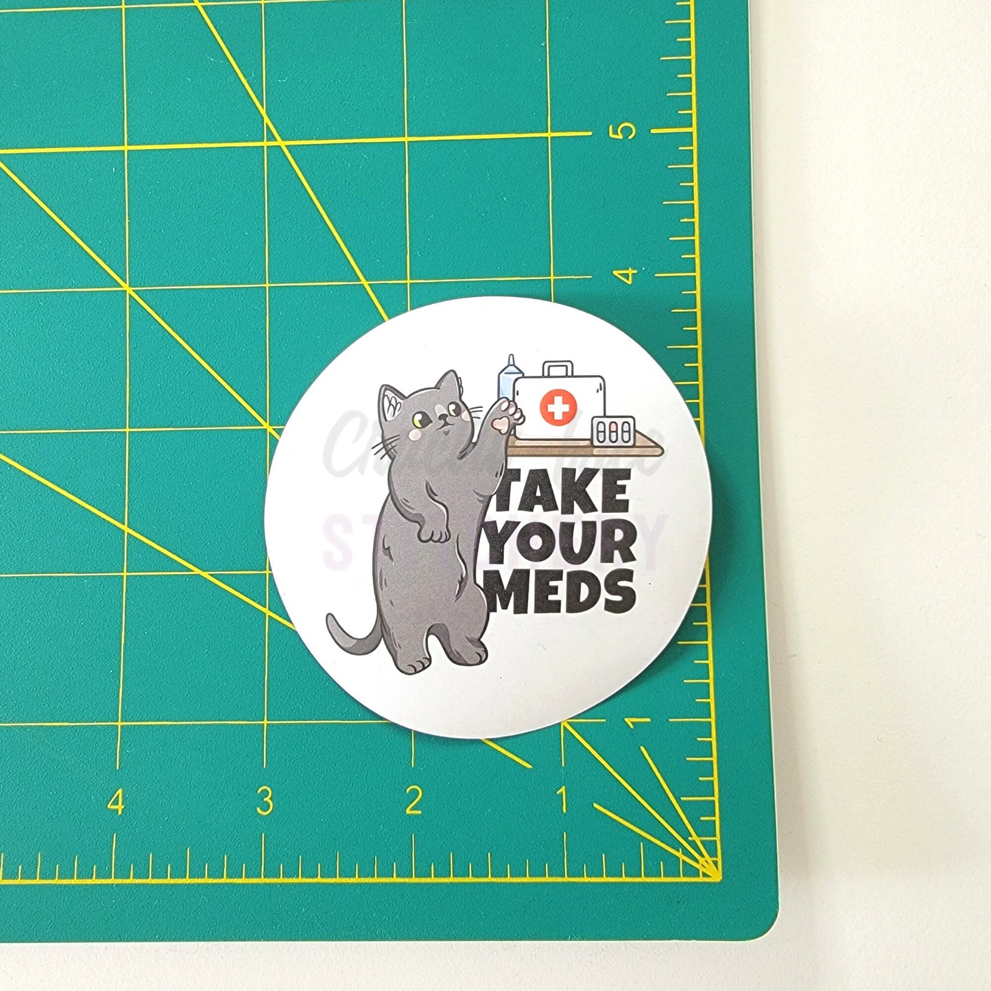 The &quot;take your meds&quot; sticker on a ruler, it is a 3 inch wide circle.