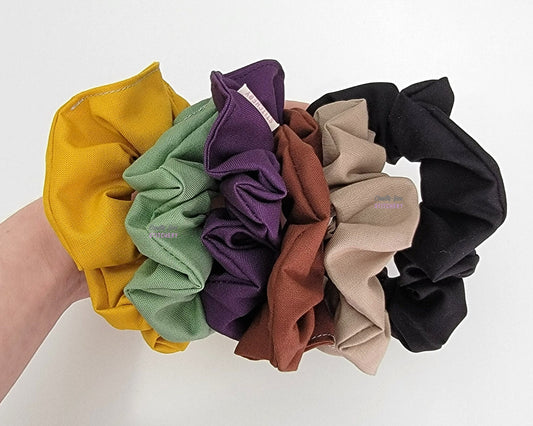 Bundle of solid color scrunchies - mustard yellow, sage green, dark purple, chocolate brown, light tan, and black.