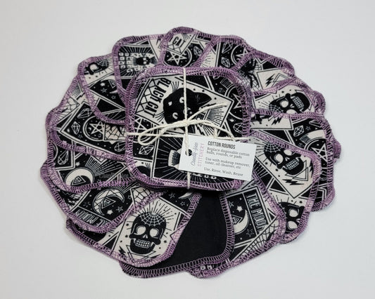 Tarot cards print reusable cotton rounds, arranged in a circle with a bundled pack in the center. They are a rounded square shape, and stitched together with light purple thread.