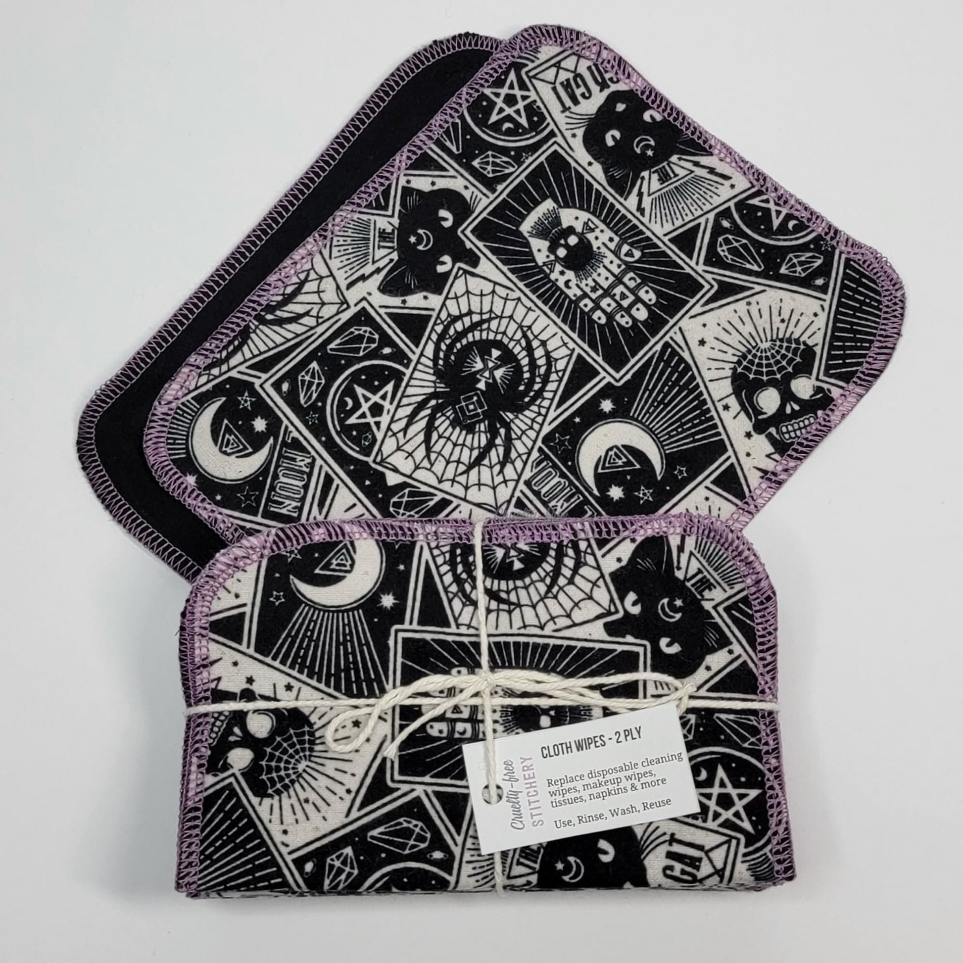 A bundled pack of tarot cards cloth wipes, on top of a wipe laid flat, to show the bundles are folded.