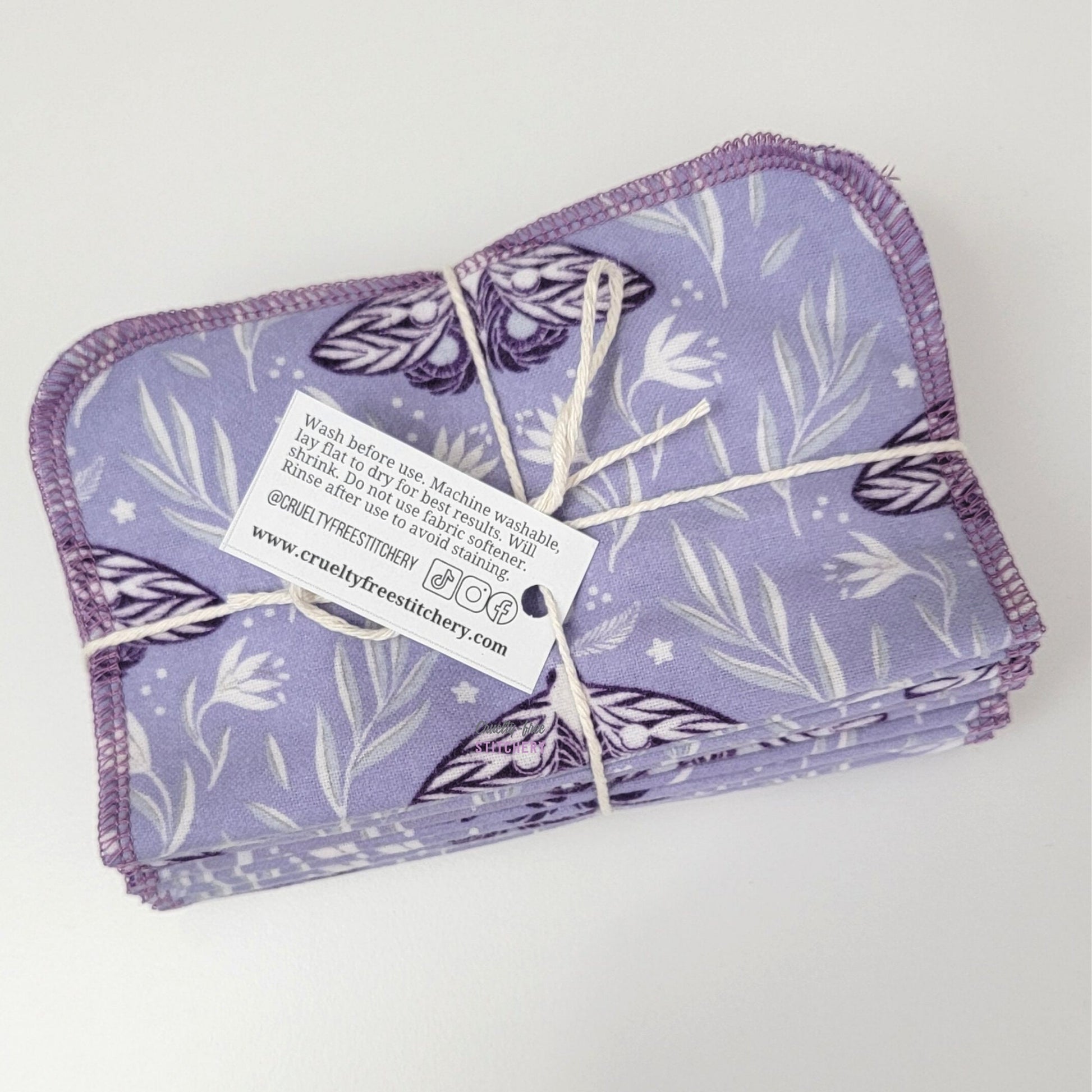Bundled purple moths cloth wipes with the back of the small white tag showing.