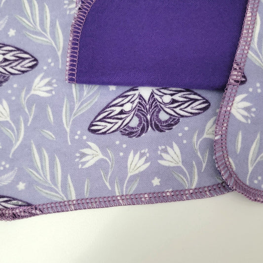 Close-up of the purple moths cloth wipes to show the stitching and the design.